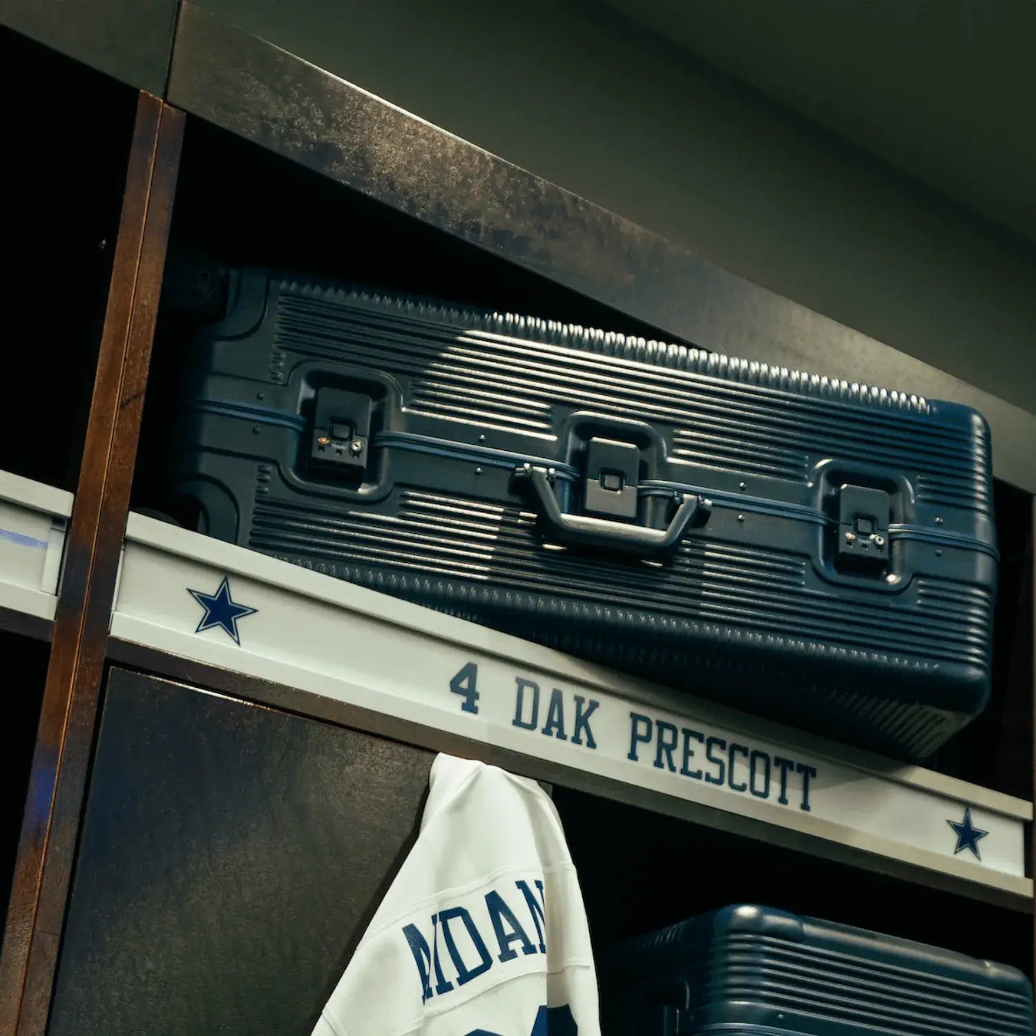 Stylish storage case in a sports locker, featuring a signed jersey of Dak Prescott neatly displayed below.